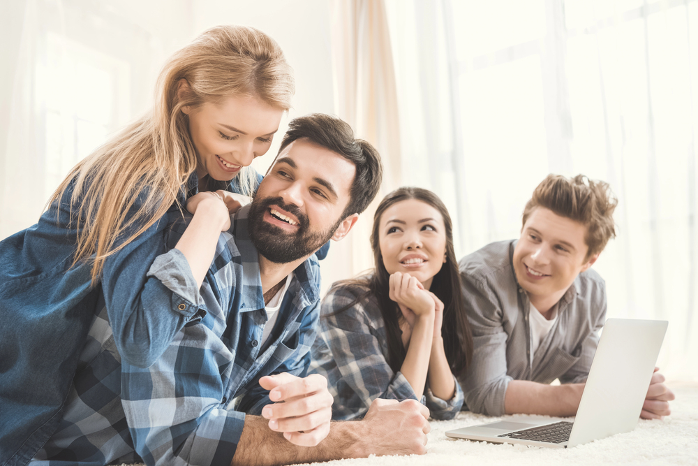 Do open relationships work? Two couples hang out together, smiling, showing satisfaction with one another